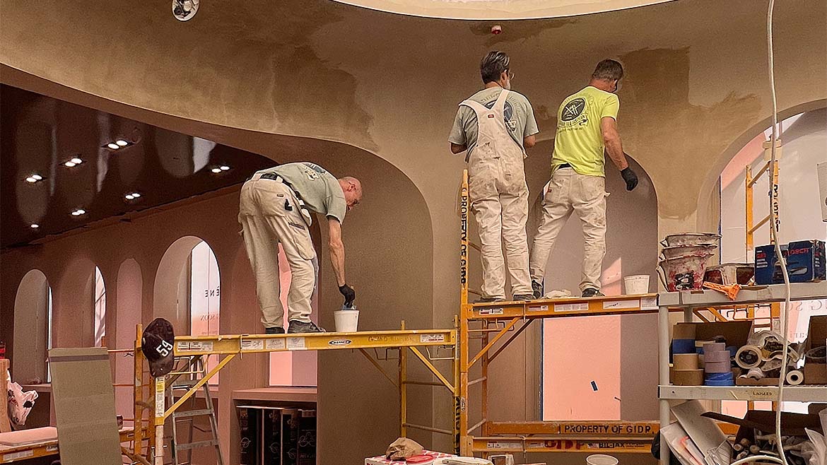Plastered arches A work crew applying plaster