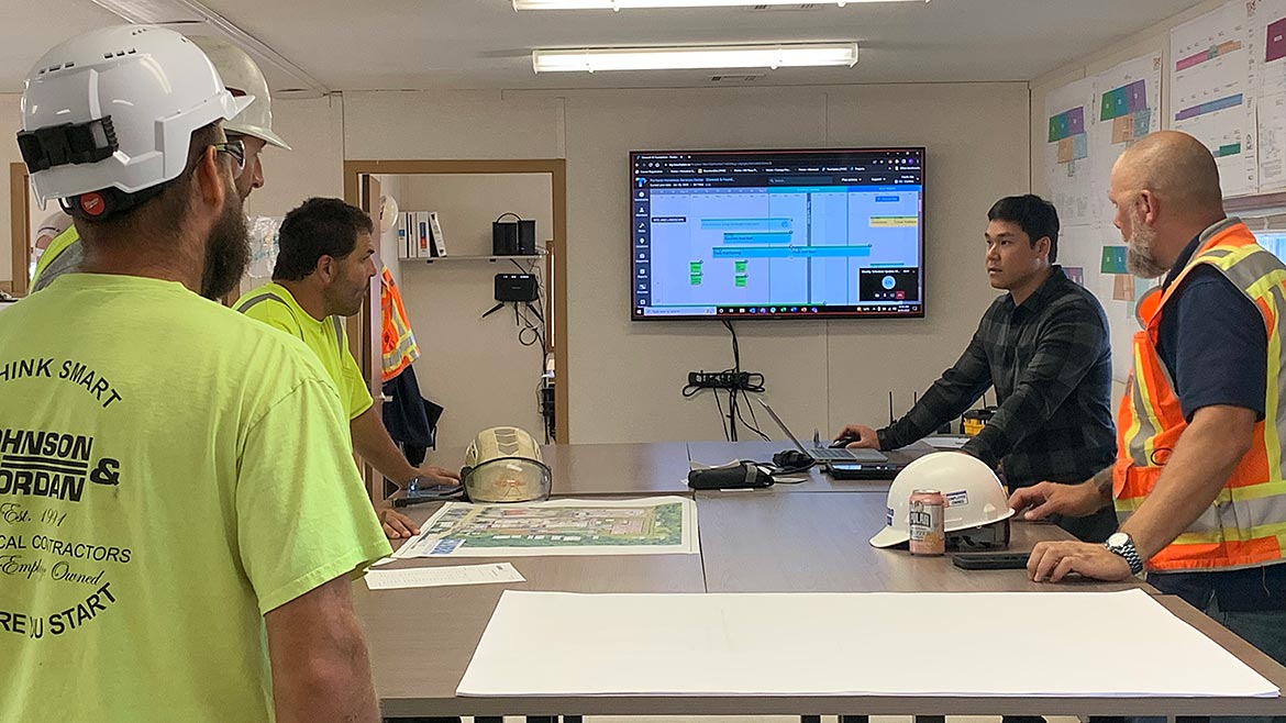 Four men discussing a construction project